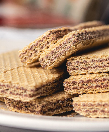 Wafer with cocholate on a white plate. Food, Dessert, Sweet, Crunchy, Tasty.